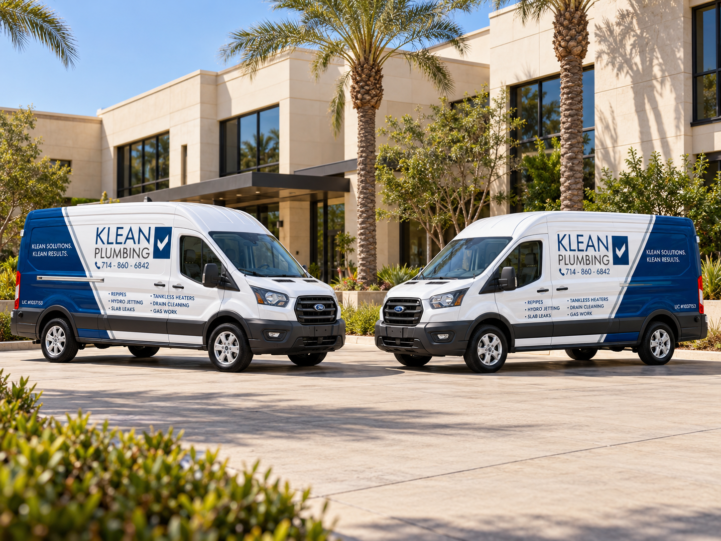 Two Klean Plumbing vans at a commercial building